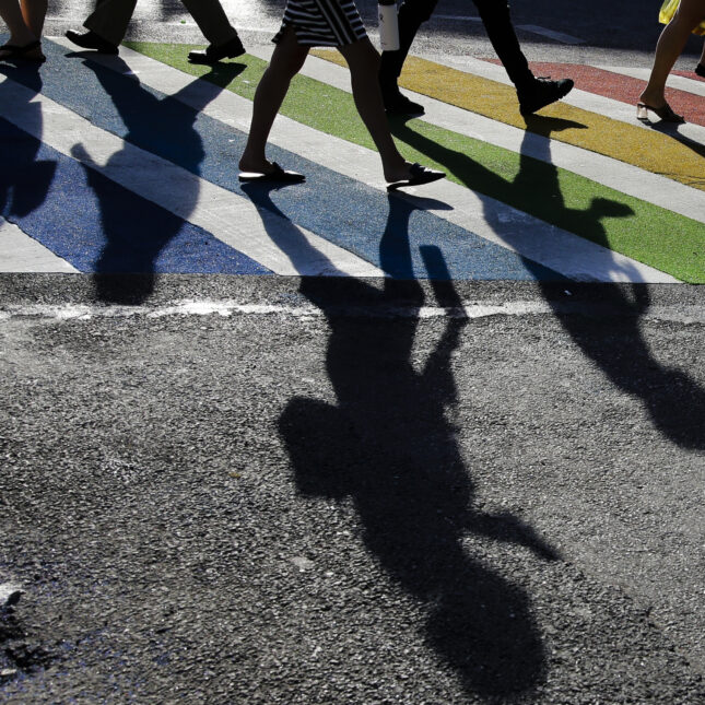 Pedestrians walks through a rainbow crosswalk near the Stonewall Inn — first opinion coverage from STAT