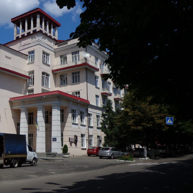 The exterior of Dnipro State Medical University foregrounded by trees on the side — health coverage from STAT