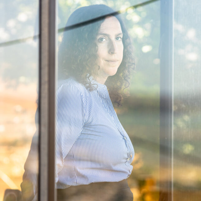 Jean Swidler looks out the window at her home. -- health coverage from STAT